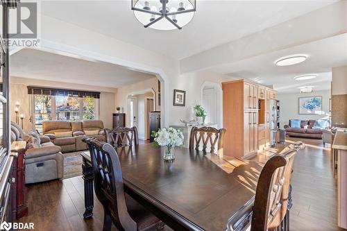 Dining room with dark wood-type flooring and a notable chandelier - 2604 Homelands Drive, Mississauga, ON - Indoor Photo Showing Dining Room