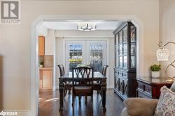 Dining room featuring an inviting chandelier and dark hardwood / wood-style flooring - 