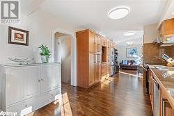 Kitchen featuring extractor fan, stainless steel appliances, dark hardwood / wood-style flooring, and backsplash - 