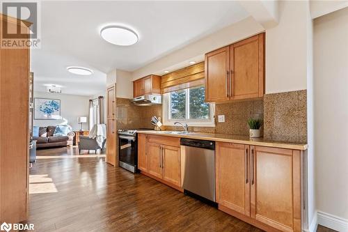 Kitchen featuring stainless steel appliances, sink, tasteful backsplash, and dark hardwood / wood-style flooring - 2604 Homelands Drive, Mississauga, ON - Indoor Photo Showing Kitchen With Double Sink