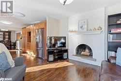 Living room featuring a fireplace and dark hardwood / wood-style floors - 