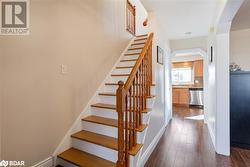 Stairway featuring sink and hardwood / wood-style flooring - 