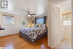 Bedroom featuring ceiling fan and light hardwood / wood-style flooring - 