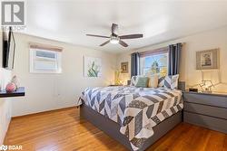 Bedroom with light wood-type flooring and ceiling fan - 