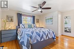 Bedroom with light hardwood / wood-style floors and ceiling fan - 