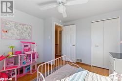 Bedroom with hardwood / wood-style flooring, ceiling fan, and a closet - 