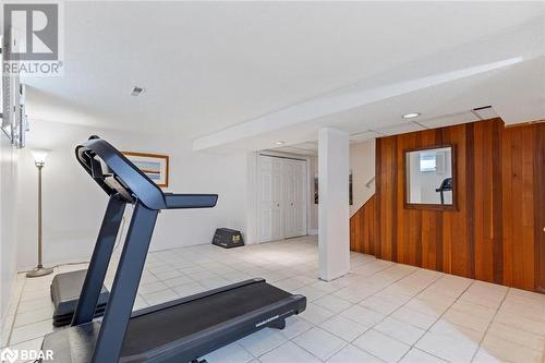 Exercise area with wooden walls and light tile patterned flooring - 2604 Homelands Drive, Mississauga, ON - Indoor Photo Showing Gym Room