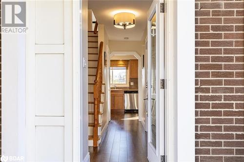 Corridor featuring dark wood-type flooring and brick wall - 2604 Homelands Drive, Mississauga, ON - Indoor Photo Showing Other Room