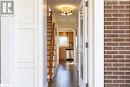 Corridor featuring dark wood-type flooring and brick wall - 2604 Homelands Drive, Mississauga, ON  - Indoor Photo Showing Other Room 