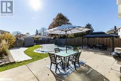 View of patio with a storage unit and a gazebo - 