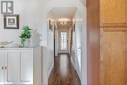 Hallway featuring dark hardwood / wood-style floors - 