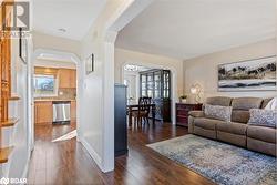 Living room with dark wood-type flooring, sink, and a textured ceiling - 