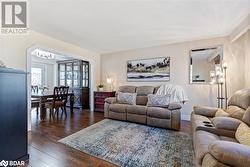 Living room with dark hardwood / wood-style floors - 