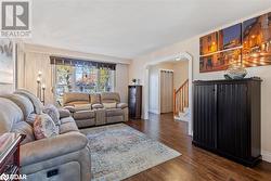 Living room with dark wood-type flooring and a textured ceiling - 