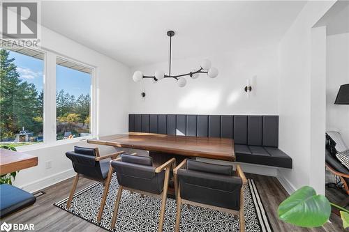 Dining space with light wood-type flooring and a notable chandelier - 18133 Loyalist Parkway, Prince Edward County, ON - 