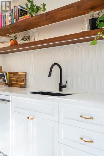 Details featuring dishwasher, tasteful backsplash, white cabinetry, and sink - 18133 Loyalist Parkway, Prince Edward County, ON - Indoor