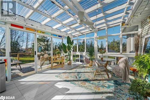 Unfurnished sunroom featuring ceiling fan and vaulted ceiling - 18133 Loyalist Parkway, Prince Edward County, ON - 