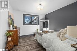 Bedroom with dark hardwood / wood-style floors - 