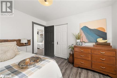 Bedroom with dark hardwood / wood-style flooring and a closet - 18133 Loyalist Parkway, Prince Edward County, ON - Indoor Photo Showing Bedroom