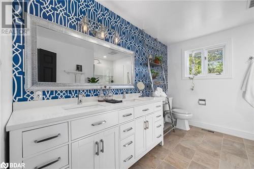 Bathroom featuring a shower, vanity, toilet, and backsplash - 18133 Loyalist Parkway, Prince Edward County, ON - Indoor Photo Showing Bathroom