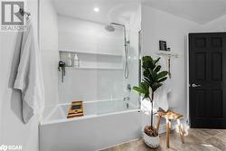 Bathroom featuring shower / bath combination with glass door - 