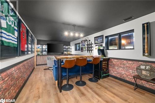 Bar featuring light hardwood / wood-style floors and brick wall - 18133 Loyalist Parkway, Prince Edward County, ON - Indoor