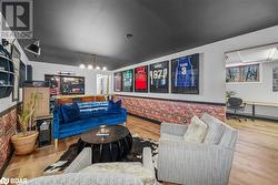 Living room with wood-type flooring, built in desk, and brick wall - 