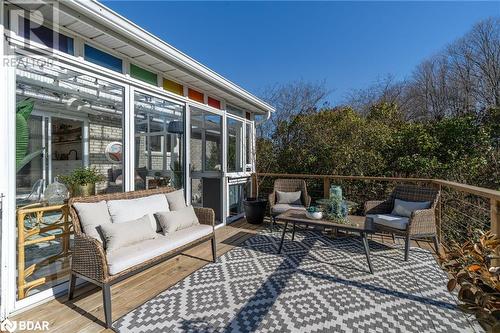 Wooden deck featuring an outdoor living space and a sunroom - 18133 Loyalist Parkway, Prince Edward County, ON - Outdoor With Deck Patio Veranda