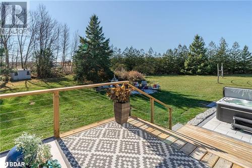 Wooden deck with a lawn and a hot tub - 18133 Loyalist Parkway, Prince Edward County, ON - Outdoor With Backyard