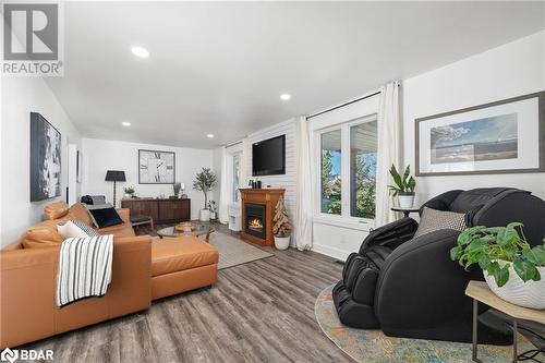 Living room featuring hardwood / wood-style floors - 18133 Loyalist Parkway, Prince Edward County, ON - Indoor Photo Showing Living Room With Fireplace