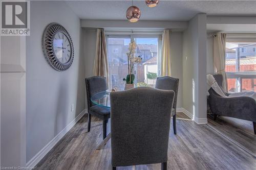 Dining area with hardwood / wood-style flooring and a textured ceiling - 83 Bridlewreath Street, Kitchener, ON - Indoor Photo Showing Dining Room