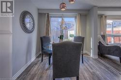 Dining area with hardwood / wood-style flooring and a textured ceiling - 