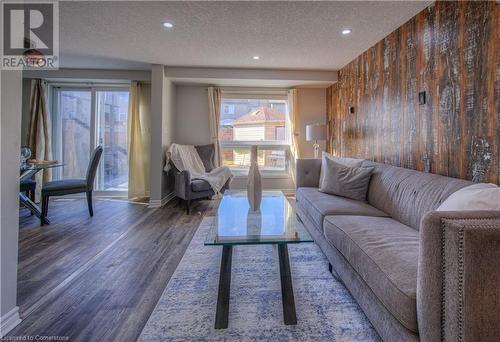 Living room featuring dark hardwood / wood-style flooring and a textured ceiling - 83 Bridlewreath Street, Kitchener, ON - Indoor Photo Showing Living Room