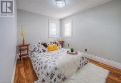 Bedroom featuring dark hardwood / wood-style floors and a textured ceiling - 