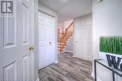 Hallway with wood-type flooring and a textured ceiling - 