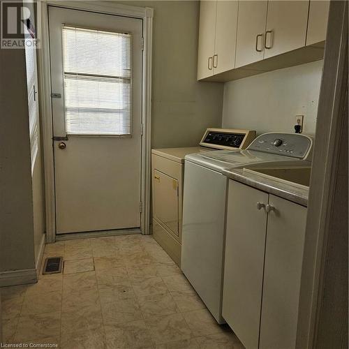 Laundry area featuring separate washer and dryer and cabinets - 115 Cranston Avenue, Cambridge, ON - Indoor Photo Showing Laundry Room