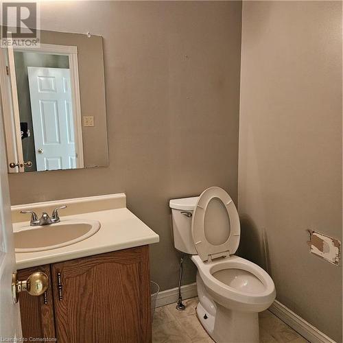 Bathroom featuring toilet, vanity, and tile patterned flooring - 115 Cranston Avenue, Cambridge, ON - Indoor Photo Showing Bathroom