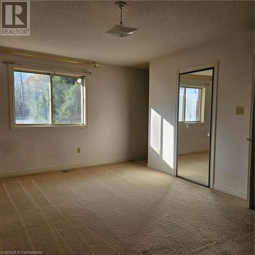 Empty room with carpet and a textured ceiling - 115 Cranston Avenue, Cambridge, ON - Indoor Photo Showing Other Room