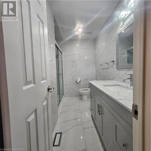 Bathroom featuring vanity, toilet, an enclosed shower, and tile walls - 115 Cranston Avenue, Cambridge, ON - Indoor Photo Showing Bathroom