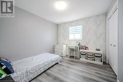 Bedroom with a closet and light wood-type flooring - 