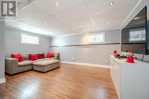 Living room featuring wood-type flooring, a healthy amount of sunlight, and crown molding - 192 Severn Drive, Guelph, ON - Indoor