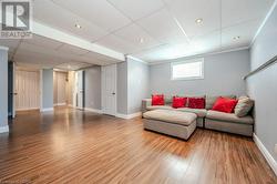 Living room featuring hardwood / wood-style flooring, a paneled ceiling, and ornamental molding - 