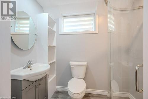 Bathroom featuring wood-type flooring, toilet, vanity, and a shower - 192 Severn Drive, Guelph, ON - Indoor Photo Showing Bathroom