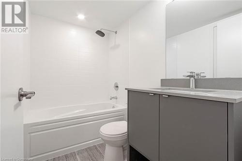 Full bathroom with toilet, vanity, tiled shower / bath, and hardwood / wood-style floors - 1095 Cooke Boulevard Unit# 42, Burlington, ON - Indoor Photo Showing Bathroom