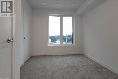 Unfurnished room featuring light colored carpet - 1095 Cooke Boulevard Unit# 42, Burlington, ON - Indoor Photo Showing Other Room