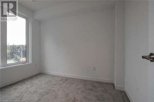 Empty room featuring light carpet - 1095 Cooke Boulevard Unit# 42, Burlington, ON - Indoor Photo Showing Other Room