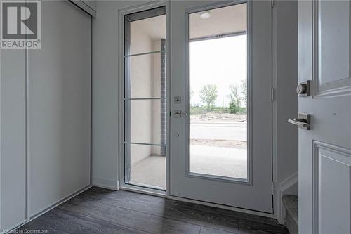 Doorway to outside featuring dark wood-type flooring and plenty of natural light - 1095 Cooke Boulevard Unit# 42, Burlington, ON - Indoor Photo Showing Other Room