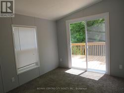 2nd bedroom with patio doors to deck - 