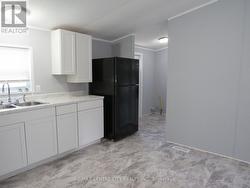 Kitchen next to laundry and side exit - 