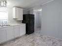 Kitchen next to laundry and side exit - 128 - 198 Springbank Drive, London, ON  - Indoor Photo Showing Kitchen With Double Sink 